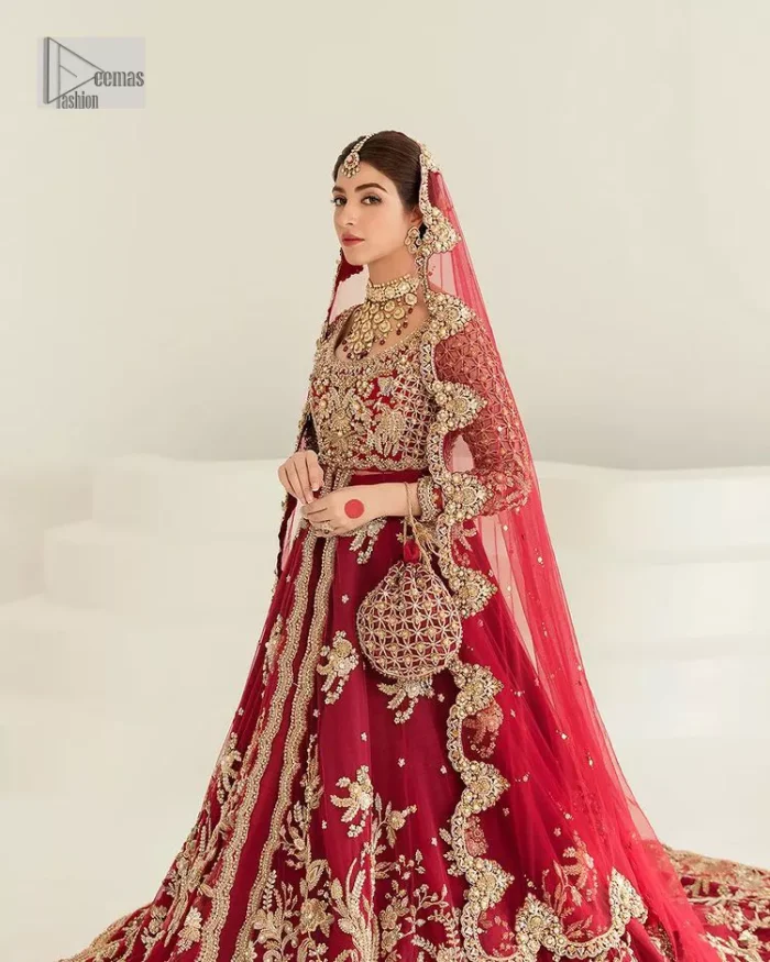 Be a dreamy vision in this reception wear. The beautiful pishwas in the bright red shade is embellished with intricate designs and fine details. It is enhanced with hand-crafted golden embroidery with details of tilla, dabka, kora, Kundan and magic of Zardozi. The round neckline and three-quarter sleeves feature a heavily crafted geometric pattern enhanced by cutwork detailing. The following front open scalloped pishwas is organized with a back train lehenga whose border is beautifully decorated with embroidery making it an epitome of beauty and grace. Furthermore, The embellished borders of the red scalloped dupatta give a perfectly glamorous look to the beautiful overall outfit. It is also intensified with sequins spray.