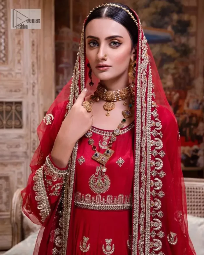 The traditional style is the new thing in the market. The stunning pishwas in the deep red shade is an eye-catching attire that gives you your desired dreamy appearance on your Big day. Beautiful work of zardozi, tilla, dabka, kora, Kundan, pearls, and beads make this attire an epitome of glamour and royalty. Embellished borders, as well as the bodice, gives an enchanting touch to this pishwas. Further, the round neckline of the outfit gives a royal touch. Further, fancy floral motifs are also adorned on the sleeves of this reception wear. It is organized with a dupatta framed with a four-sided border and sparkling tiny floral motifs all over.