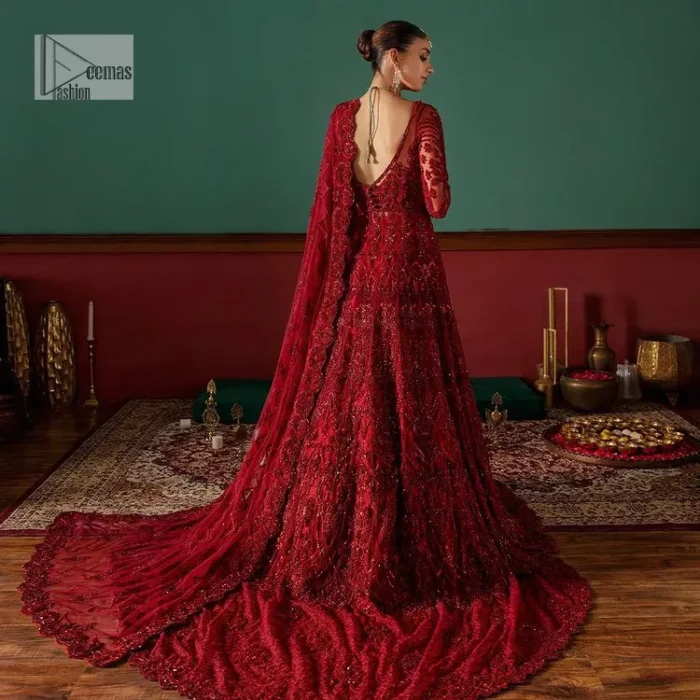 Deep red is just associated with love and romance! For a more lovely and romantic look on your big day just buy this reception wear. The deep red maxi is heavily adorned with intricate hand-worked of tilla, dabka, kora, Kundan and Zardozi in the shade of red which is sure to make you look glamorous on your big day. The square neckline merges rich traditions with modern style. Further, the full sleeves of the maxi also add more charms. It is organized with a back train lehenga which is also embellished and highlighted with floral motifs. Complete this super romantic look with a dupatta which is encrusted with four-sided embellished borders and floral motifs sprinkled all over. 