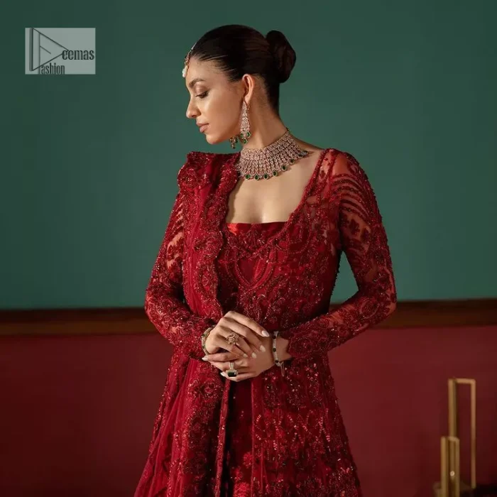 Deep red is just associated with love and romance! For a more lovely and romantic look on your big day just buy this reception wear. The deep red maxi is heavily adorned with intricate hand-worked of tilla, dabka, kora, Kundan and Zardozi in the shade of red which is sure to make you look glamorous on your big day. The square neckline merges rich traditions with modern style. Further, the full sleeves of the maxi also add more charms. It is organized with a back train lehenga which is also embellished and highlighted with floral motifs. Complete this super romantic look with a dupatta which is encrusted with four-sided embellished borders and floral motifs sprinkled all over. 