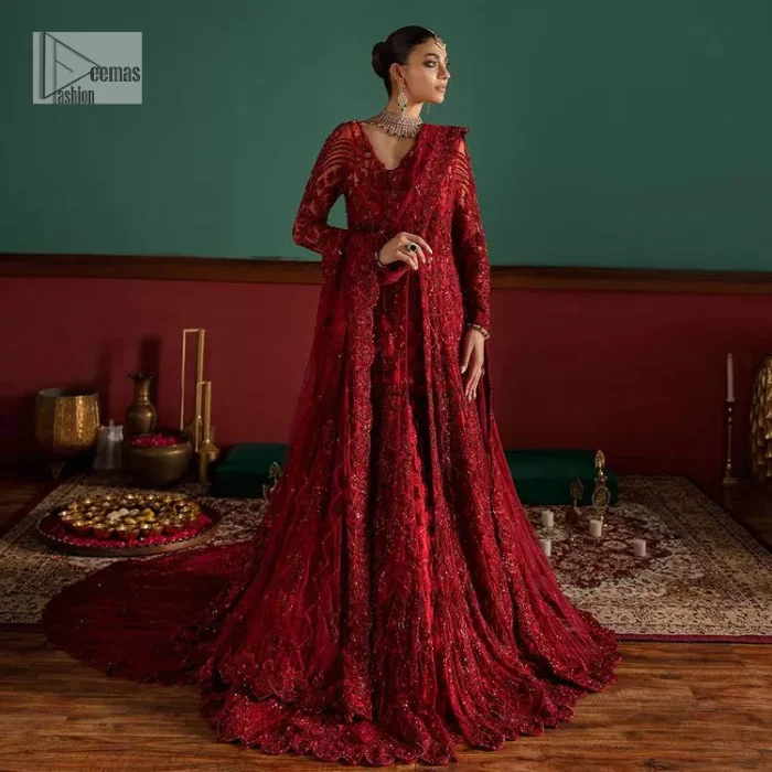 Deep red is just associated with love and romance! For a more lovely and romantic look on your big day just buy this reception wear. The deep red maxi is heavily adorned with intricate hand-worked of tilla, dabka, kora, Kundan and Zardozi in the shade of red which is sure to make you look glamorous on your big day. The square neckline merges rich traditions with modern style. Further, the full sleeves of the maxi also add more charms. It is organized with a back train lehenga which is also embellished and highlighted with floral motifs. Complete this super romantic look with a dupatta which is encrusted with four-sided embellished borders and floral motifs sprinkled all over. 