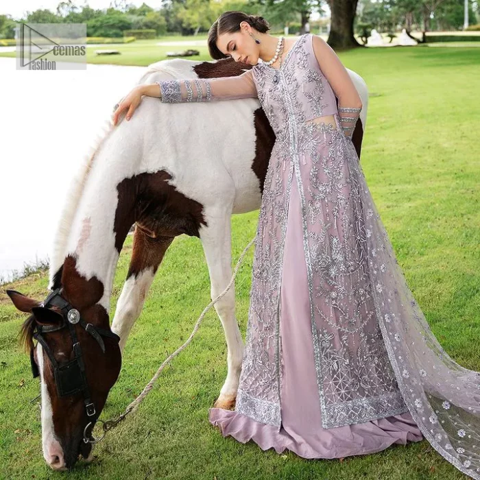 Lilac article on your Big day is like a pro. This lilac front open gown in the lilac shade is the epitome of royalty and grace. The gorgeous gown is adorned with silver dabka, pearls,tilla, kora, Kundan, zardozi and the real magic of beads. It is prominent with silver embroidery. The following gown has a V shape neckline to make this outfit remarkable. Further, the beautiful embroidery is adorned on full sleeves. The fully embellished lilac Gown will look perfect when paired with a set of plain lehenga choli. It is organized with a dupatta framed with four-sided borders and tiny floral motifs all over to gain pro magic.