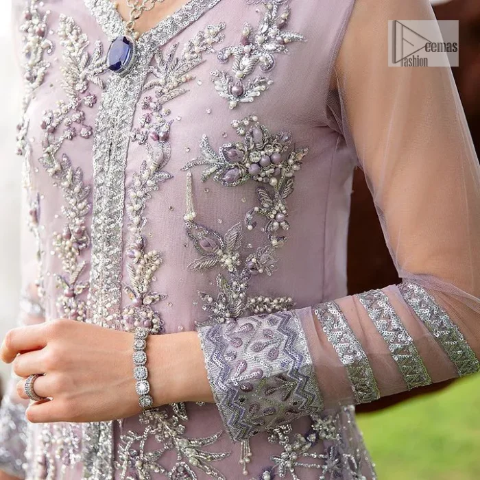 Lilac article on your Big day is like a pro. This lilac front open gown in the lilac shade is the epitome of royalty and grace. The gorgeous gown is adorned with silver dabka, pearls,tilla, kora, Kundan, zardozi and the real magic of beads. It is prominent with silver embroidery. The following gown has a V shape neckline to make this outfit remarkable. Further, the beautiful embroidery is adorned on full sleeves. The fully embellished lilac Gown will look perfect when paired with a set of plain lehenga choli. It is organized with a dupatta framed with four-sided borders and tiny floral motifs all over to gain pro magic.