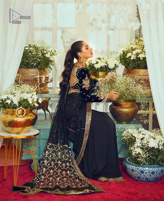 Black, is a reminder to love yourself. The navy blue blouse is augmented with elusive dabka and remarkable naqshi to highlight the grace and is further enhanced with tilla, dabka, koran and Kundan.  The V shape neckline of the following blouse is beautifully decorated with multiple colour embroidery. In addition to this, the heavy floral motifs also adorned the full sleeves to add more charm and beauty to this party wear. It is paired with a black saree to style you according to your choice. Complex work on the borders and the pallu makes it look even more gorgeous. This is a beautiful piece for a bridesmaid who has traditional taste.