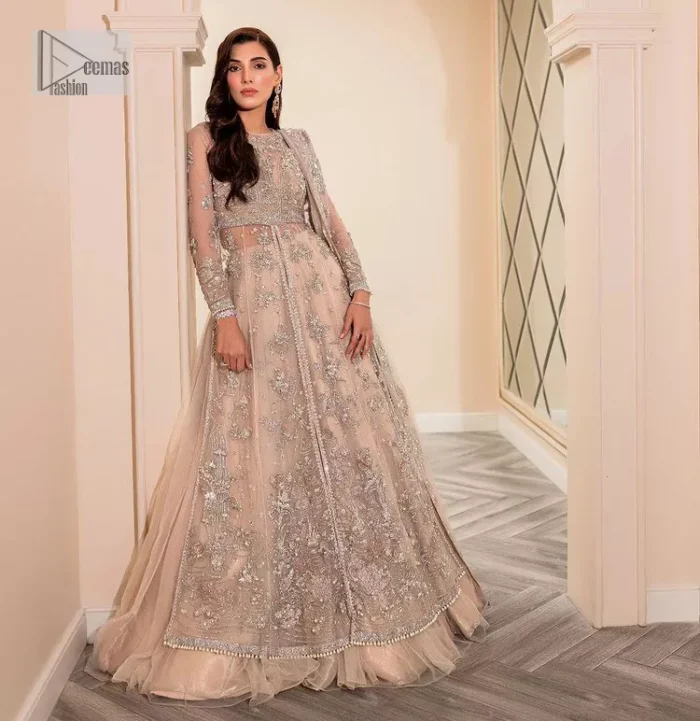 Get ready to lost in the world with floral and trendy designs. This dress is beautifully decorated with heavy embroidery. It is highlighted with kora, dabka, tilla, sequins and pearls. The shirt is enhanced with zardozi work on a jewel neckline. It comes with a plain lehenga in the same colour to balance the beautiful outfit. It is coordinated with a tissue dupatta which is sprinkled with sequins all over it. It is further furnished with a four-sided embellished border giving a perfectly glamorous look to the whole nikah wear. 