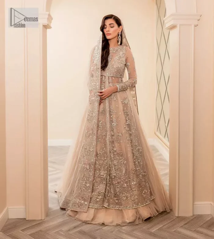 Get ready to lost in the world with floral and trendy designs. This dress is beautifully decorated with heavy embroidery. It is highlighted with kora, dabka, tilla, sequins and pearls. The shirt is enhanced with zardozi work on a jewel neckline. It comes with a plain lehenga in the same colour to balance the beautiful outfit. It is coordinated with a tissue dupatta which is sprinkled with sequins all over it. It is further furnished with a four-sided embellished border giving a perfectly glamorous look to the whole nikah wear. 