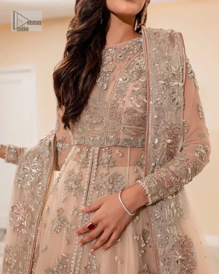 Get ready to lost in the world with floral and trendy designs. This dress is beautifully decorated with heavy embroidery. It is highlighted with kora, dabka, tilla, sequins and pearls. The shirt is enhanced with zardozi work on a jewel neckline. It comes with a plain lehenga in the same colour to balance the beautiful outfit. It is coordinated with a tissue dupatta which is sprinkled with sequins all over it. It is further furnished with a four-sided embellished border giving a perfectly glamorous look to the whole nikah wear. 