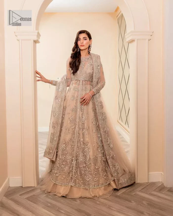 Get ready to lost in the world with floral and trendy designs. This dress is beautifully decorated with heavy embroidery. It is highlighted with kora, dabka, tilla, sequins and pearls. The shirt is enhanced with zardozi work on a jewel neckline. It comes with a plain lehenga in the same colour to balance the beautiful outfit. It is coordinated with a tissue dupatta which is sprinkled with sequins all over it. It is further furnished with a four-sided embellished border giving a perfectly glamorous look to the whole nikah wear. 