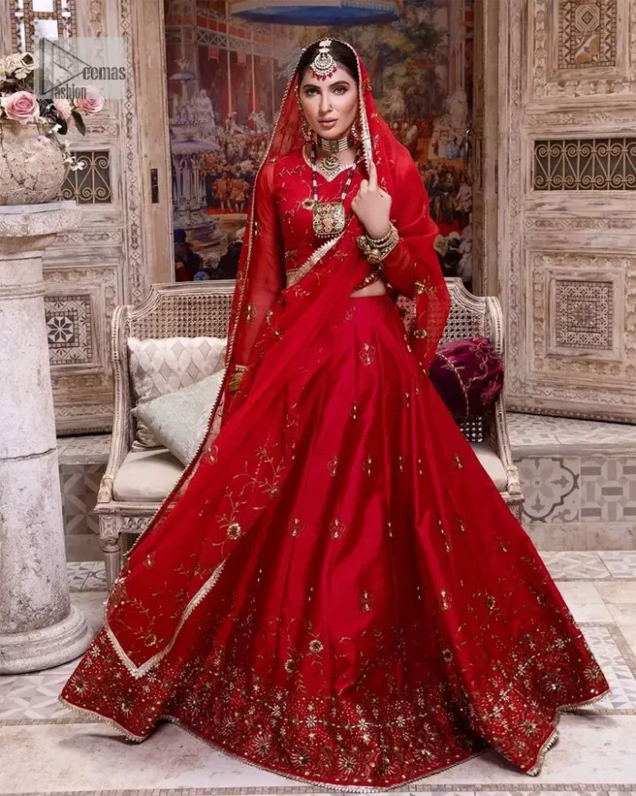 Statement suiting in red. This red blouse comes with a lehenga and dupatta in premium fabric quality. The blouse is beautifully decorated with fine embroidery work accompanied by iridescent sequins, tilla, dabka, kora and Zardozi. Furthermore, beautiful artistry on the neckline is highlighted with golden embroidery accompanied by cutwork counting more to the elegance of this luxurious attire. It is organized with a flared lehenga in the same colour. This embroidered lehenga comes is very neatly stitched and decorated with lavish embroidery and minimal floral motifs making this dreamy attire look heavenly and your ultimate priority. Complete this reception wear with a dupatta framed with four-sided embellished borders that is your favourite statement on your big day.