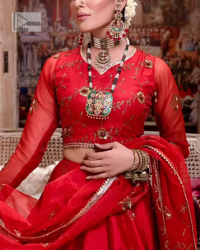 Statement suiting in red. This red blouse comes with a lehenga and dupatta in premium fabric quality. The blouse is beautifully decorated with fine embroidery work accompanied by iridescent sequins, tilla, dabka, kora and Zardozi. Furthermore, beautiful artistry on the neckline is highlighted with golden embroidery accompanied by cutwork counting more to the elegance of this luxurious attire. It is organized with a flared lehenga in the same colour. This embroidered lehenga comes is very neatly stitched and decorated with lavish embroidery and minimal floral motifs making this dreamy attire look heavenly and your ultimate priority. Complete this reception wear with a dupatta framed with four-sided embellished borders that is your favourite statement on your big day.