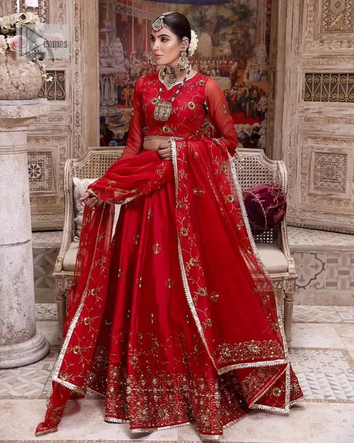Statement suiting in red. This red blouse comes with a lehenga and dupatta in premium fabric quality. The blouse is beautifully decorated with fine embroidery work accompanied by iridescent sequins, tilla, dabka, kora and Zardozi. Furthermore, beautiful artistry on the neckline is highlighted with golden embroidery accompanied by cutwork counting more to the elegance of this luxurious attire. It is organized with a flared lehenga in the same colour. This embroidered lehenga comes is very neatly stitched and decorated with lavish embroidery and minimal floral motifs making this dreamy attire look heavenly and your ultimate priority. Complete this reception wear with a dupatta framed with four-sided embellished borders that is your favourite statement on your big day.