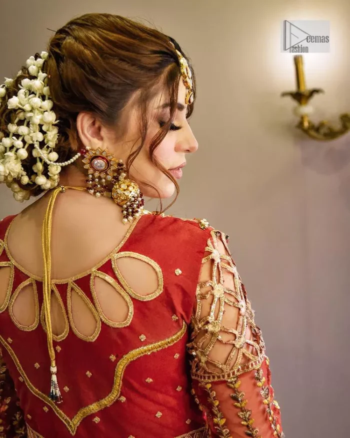 The deep orange colour is the perfect feminine and delicate shade with its meticulously crafted untruth. The stunning maxi is ornamented with tilla, dabka, kora, Kundan, Zardozi and crystals. Embroidery is done in the shade of gold.  The illusion neckline of the maxi just steals everyone's heart. Further, the full sleeves of the maxi are also decorated with geometric patterns. The frill of the following maxi gives a perfectly glamorous look to the whole reception wear. It is paired up with a dupatta which is adorned with floral motifs all over.