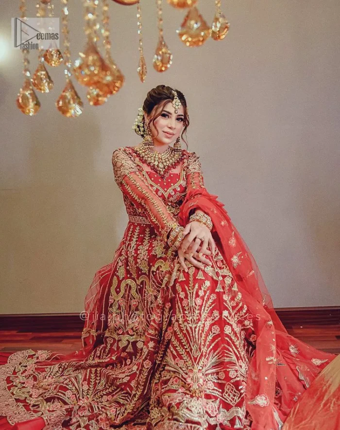 The deep orange colour is the perfect feminine and delicate shade with its meticulously crafted untruth. The stunning maxi is ornamented with tilla, dabka, kora, Kundan, Zardozi and crystals. Embroidery is done in the shade of gold.  The illusion neckline of the maxi just steals everyone's heart. Further, the full sleeves of the maxi are also decorated with geometric patterns. The frill of the following maxi gives a perfectly glamorous look to the whole reception wear. It is paired up with a dupatta which is adorned with floral motifs all over.