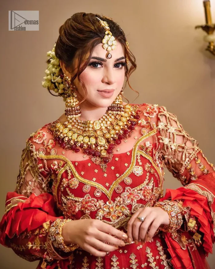 The deep orange colour is the perfect feminine and delicate shade with its meticulously crafted untruth. The stunning maxi is ornamented with tilla, dabka, kora, Kundan, Zardozi and crystals. Embroidery is done in the shade of gold.  The illusion neckline of the maxi just steals everyone's heart. Further, the full sleeves of the maxi are also decorated with geometric patterns. The frill of the following maxi gives a perfectly glamorous look to the whole reception wear. It is paired up with a dupatta which is adorned with floral motifs all over.