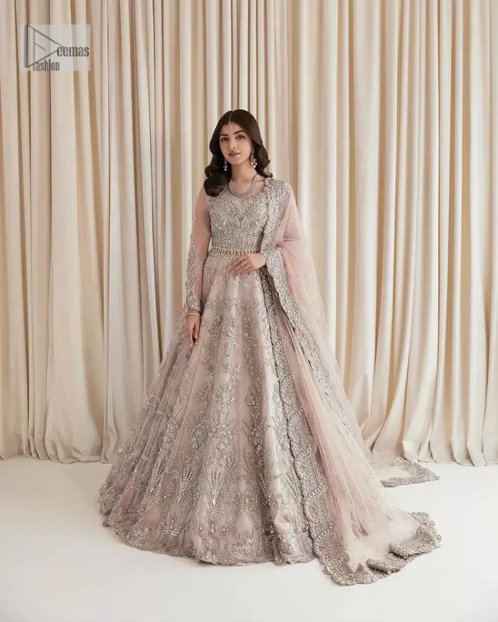 Rose Pink, is the colour of confidence on your big day. The blouse in the rose pink shade is embellished with intricate designs, silverwork, and fine details. The V shape neckline and full sleeves look perfect with the lehenga. Beautiful details of crystals, tilla, dabka, kora, stones, and dabka give a perfect finishing look to the following blouse. It is organized with a lehenga which is heavily adorned with silver embroidery to add more charm and beauty to the outfit. Complete this outfit with a dupatta framed with four-sided borders that gives an elegant look to the gorgeous bride.