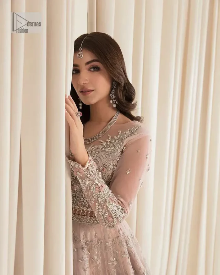 Rose Pink, is the colour of confidence on your big day. The blouse in the rose pink shade is embellished with intricate designs, silverwork, and fine details. The V shape neckline and full sleeves look perfect with the lehenga. Beautiful details of crystals, tilla, dabka, kora, stones, and dabka give a perfect finishing look to the following blouse. It is organized with a lehenga which is heavily adorned with silver embroidery to add more charm and beauty to the outfit. Complete this outfit with a dupatta framed with four-sided borders that gives an elegant look to the gorgeous bride.