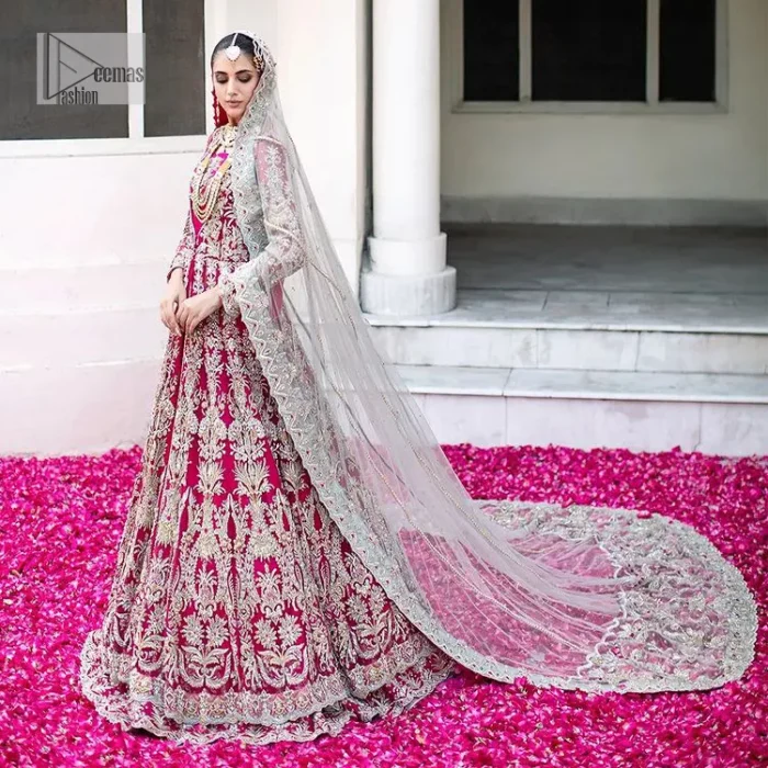 Be a dream vision in this floral shocking pink article. The shocking pink maxi is a breathtaking masterpiece that wins everyone's hearts at the very first glance. The stunning details of silver embroidery which includes tilla, dabka, kora, Kundan and zardozi give a royal touch to this scalloped maxi. The front open style and sweetheart neckline come together to make this outfit lovely and charming. The full sleeves give a glamorous touch to this perfectly maxi. It is paired with Lehenga to create a lavish look. The Lehenga has a huge flare and is also embellished with beautiful embroidery. Complete this walima article with a grey dupatta in a scalloped design which is adorned with a four-sided heavy embellishment. 