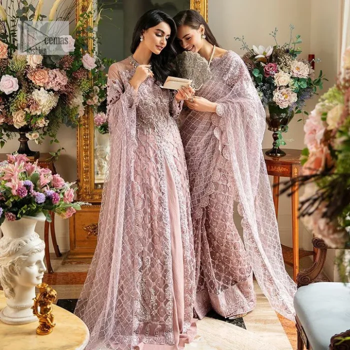 Incoming: that nikkah feeling with some flowers. Unique maxi for nikkah outfit in soft pink colour is embellished with silver pearls sequins, kora, dabka, tilla, Zardozi and Kundan work. Maxi Sleeves are fully embellished with embroidery and are in floral patterns. The Jewel neckline also makes this masterpiece unique and charming. Maxi Hemline is decorated with embroidery on the border. Further, the front open style makes it a perfect choice to pair with the dupatta. It is organized with a plain lehenga to balance the overall outfit. Complete this article with a dupatta framed with four-sided embellished scalloped borders and sequins sprayed all over.