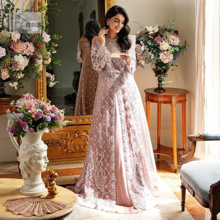 Incoming: that nikkah feeling with some flowers. Unique maxi for nikkah outfit in soft pink colour is embellished with silver pearls sequins, kora, dabka, tilla, Zardozi and Kundan work. Maxi Sleeves are fully embellished with embroidery and are in floral patterns. The Jewel neckline also makes this masterpiece unique and charming. Maxi Hemline is decorated with embroidery on the border. Further, the front open style makes it a perfect choice to pair with the dupatta. It is organized with a plain lehenga to balance the overall outfit. Complete this article with a dupatta framed with four-sided embellished scalloped borders and sequins sprayed all over.