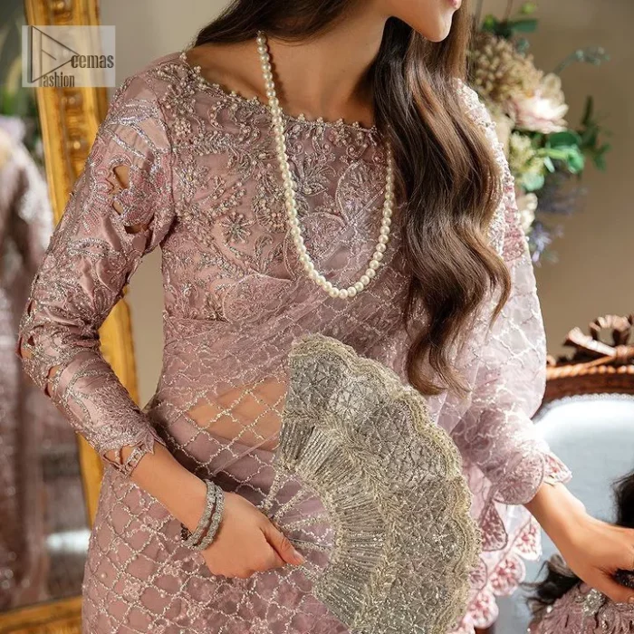 Incoming: that nikkah feeling with some flowers. Unique maxi for nikkah outfit in soft pink colour is embellished with silver pearls sequins, kora, dabka, tilla, Zardozi and Kundan work. Maxi Sleeves are fully embellished with embroidery and are in floral patterns. The Jewel neckline also makes this masterpiece unique and charming. Maxi Hemline is decorated with embroidery on the border. Further, the front open style makes it a perfect choice to pair with the dupatta. It is organized with a plain lehenga to balance the overall outfit. Complete this article with a dupatta framed with four-sided embellished scalloped borders and sequins sprayed all over.