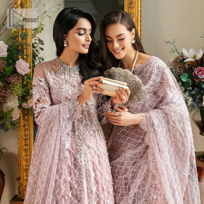 Incoming: that nikkah feeling with some flowers. Unique maxi for nikkah outfit in soft pink colour is embellished with silver pearls sequins, kora, dabka, tilla, Zardozi and Kundan work. Maxi Sleeves are fully embellished with embroidery and are in floral patterns. The Jewel neckline also makes this masterpiece unique and charming. Maxi Hemline is decorated with embroidery on the border. Further, the front open style makes it a perfect choice to pair with the dupatta. It is organized with a plain lehenga to balance the overall outfit. Complete this article with a dupatta framed with four-sided embellished scalloped borders and sequins sprayed all over.