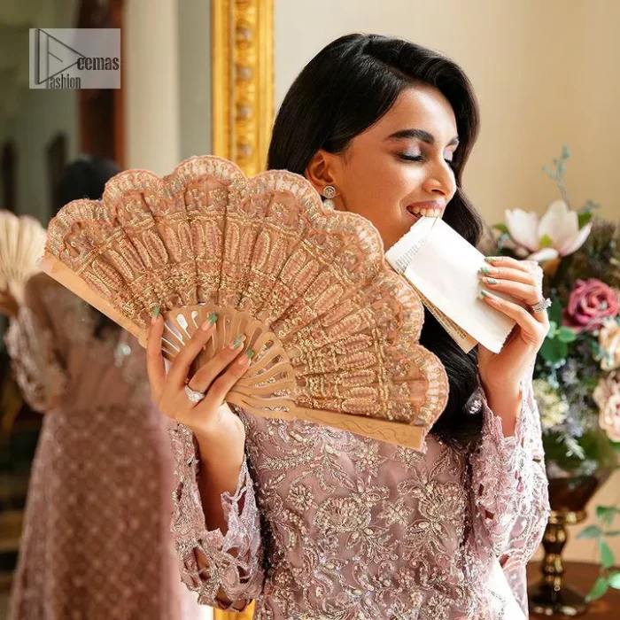 Incoming: that nikkah feeling with some flowers. Unique maxi for nikkah outfit in soft pink colour is embellished with silver pearls sequins, kora, dabka, tilla, Zardozi and Kundan work. Maxi Sleeves are fully embellished with embroidery and are in floral patterns. The Jewel neckline also makes this masterpiece unique and charming. Maxi Hemline is decorated with embroidery on the border. Further, the front open style makes it a perfect choice to pair with the dupatta. It is organized with a plain lehenga to balance the overall outfit. Complete this article with a dupatta framed with four-sided embellished scalloped borders and sequins sprayed all over.