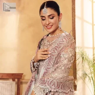 This elegantly poised ensemble defines nikah fashion in its most refined form! The scalloped maxi in premium quality is hand-embellished with beaming adornments and multiple colour embroidery. It is further enhanced with tilla, dabka, kora, Kundan and the real magic of crystals. Stunning designs on full sleeves and premium details on the illusion neckline make it an exquisite masterpiece. It is combined with sharara to balance the most demanding and delicate look. Finish this nikah wear with a dupatta in the same colour. The borders of this dupatta are heavily embellished, giving a perfectly glamorous look to the beautiful attire.