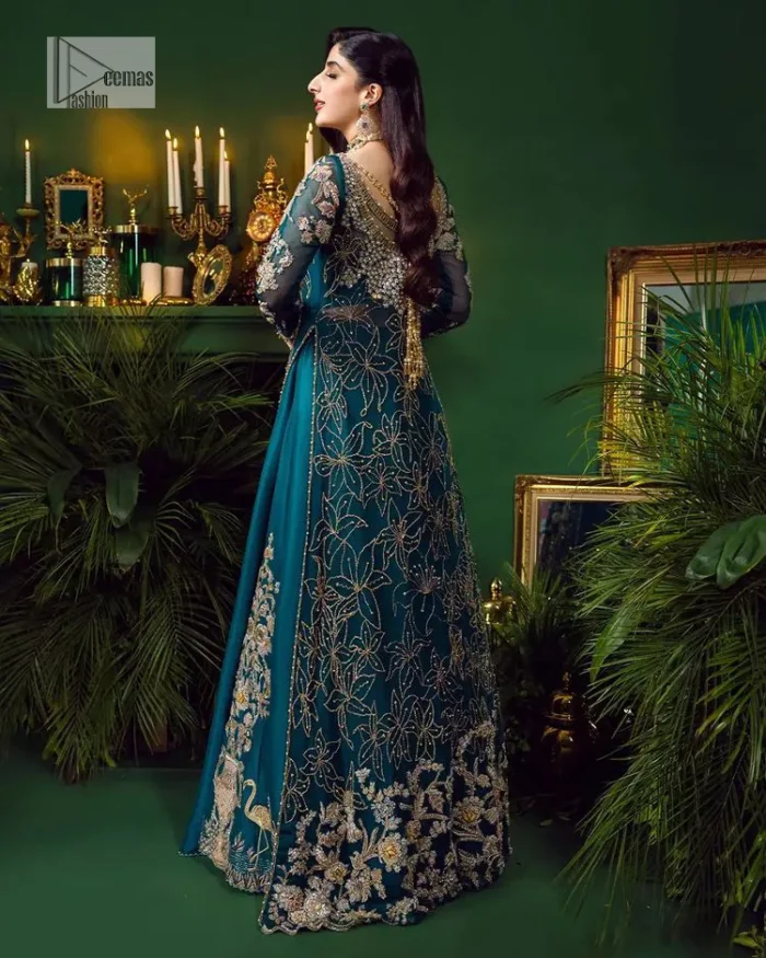 Let the outfit speak for itself! DeemasFashion presents this party wear in teal blue colour.  Be a centre of attraction by donning this beautiful teal blue long shirt embellished with tilla, dabka, kora, Kundan and sequins work which is further intensified with silver and golden embroidery. The shirt is emphasized with a sweetheart neckline and full sleeves to make your day super romantic. It is organized with a lehenga which is embellished with embroidered floral motifs to explain the love of the bride. To finish this article, the last but not least piece comes that is the dupatta which is adorned with four-sided heavily embellished borders and sequins spray that accentuates the whole look.