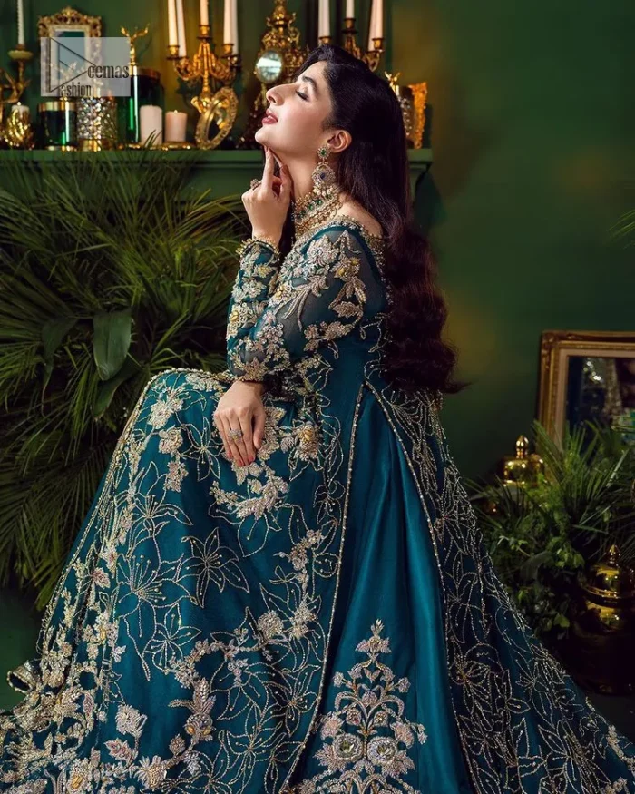 Let the outfit speak for itself! DeemasFashion presents this party wear in teal blue colour.  Be a centre of attraction by donning this beautiful teal blue long shirt embellished with tilla, dabka, kora, Kundan and sequins work which is further intensified with silver and golden embroidery. The shirt is emphasized with a sweetheart neckline and full sleeves to make your day super romantic. It is organized with a lehenga which is embellished with embroidered floral motifs to explain the love of the bride. To finish this article, the last but not least piece comes that is the dupatta which is adorned with four-sided heavily embellished borders and sequins spray that accentuates the whole look.