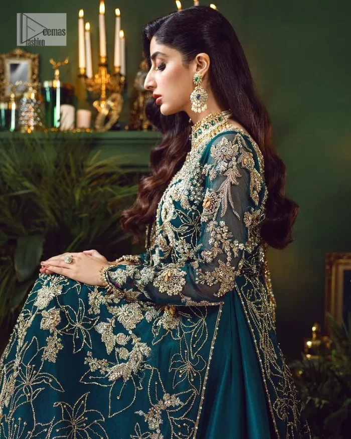 Let the outfit speak for itself! DeemasFashion presents this party wear in teal blue colour.  Be a centre of attraction by donning this beautiful teal blue long shirt embellished with tilla, dabka, kora, Kundan and sequins work which is further intensified with silver and golden embroidery. The shirt is emphasized with a sweetheart neckline and full sleeves to make your day super romantic. It is organized with a lehenga which is embellished with embroidered floral motifs to explain the love of the bride. To finish this article, the last but not least piece comes that is the dupatta which is adorned with four-sided heavily embellished borders and sequins spray that accentuates the whole look.