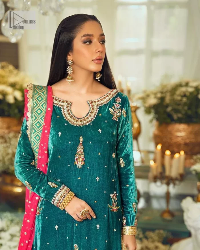 Brighten up your day with this beautiful ensemble. This long shirt style in a teal green colour is a perfect outfit that gives you a royal look on the festive occasion. The embroidered neckline and full sleeves make this outfit an epitome of beauty. Further, Embroidery work which enhances with tilla, dabka, kora, Kundan and lavish designs makes this outfit your priority for the day. It is paired with plum trousers which have finished edges to balance the overall look of the day. Complete this party wear with a dupatta in pink colour sparkling sequins spray all over. 
