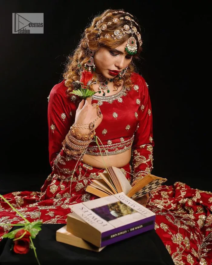 Reception called, and red answered. The stunning blouse is embellished with floral motifs. The base colour used for choli is wine red.  The sleeves of the blouse are embellished with floral patterns to make this reception wear the epitome of beauty. Further, the boat shape neckline also adds super charm and beauty when paired with a lehenga. The lehenga is adorned with golden embroidery which is further enhanced with tilla, dabka, kora, Kundan and the real magic of Zardozi. Complete this romantic article with a dupatta framed with a four-sided embellished border to give a glamorous touch to this magnificent attire.