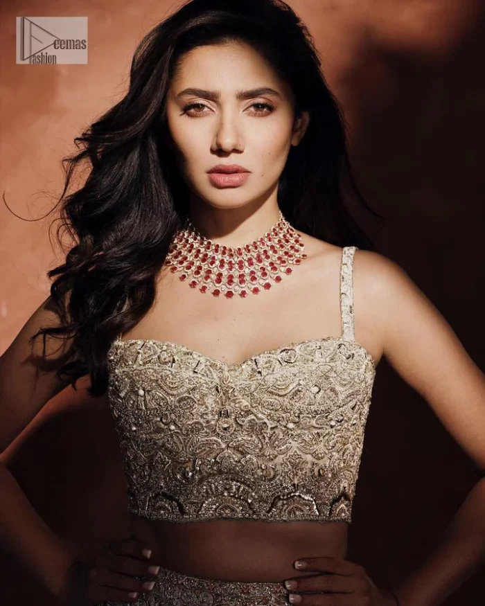 Chill vibes on your big day with this walima outfit. A soft pink blouse is embellished in tilla,dabka, kora, Kundan and crystals with a fish cut style lehenga with a huge trail at the back. The blouse has a sweetheart neckline to make this outfit romantic. Further, the blouse is embellished with silver embroidery just to make you a spotlight of the show. The sleeveless style makes this masterpiece unique and lovely. It is paired up with a fish-cut lehenga in the same colour. The heavy bak train lehenga is adorned with embroidery making a bride look more regal than a costume.