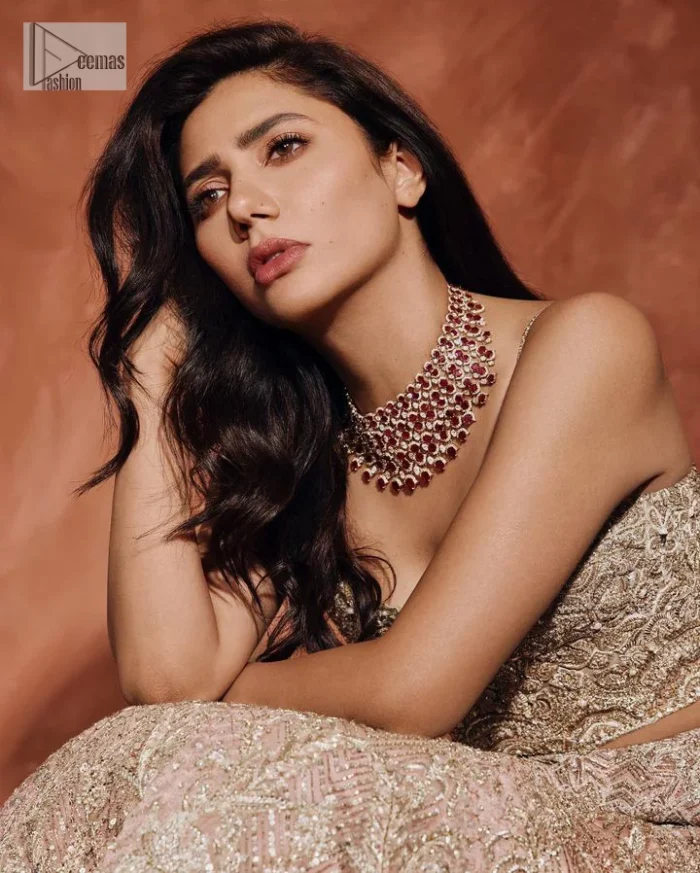 Chill vibes on your big day with this walima outfit. A soft pink blouse is embellished in tilla,dabka, kora, Kundan and crystals with a fish cut style lehenga with a huge trail at the back. The blouse has a sweetheart neckline to make this outfit romantic. Further, the blouse is embellished with silver embroidery just to make you a spotlight of the show. The sleeveless style makes this masterpiece unique and lovely. It is paired up with a fish-cut lehenga in the same colour. The heavy bak train lehenga is adorned with embroidery making a bride look more regal than a costume.