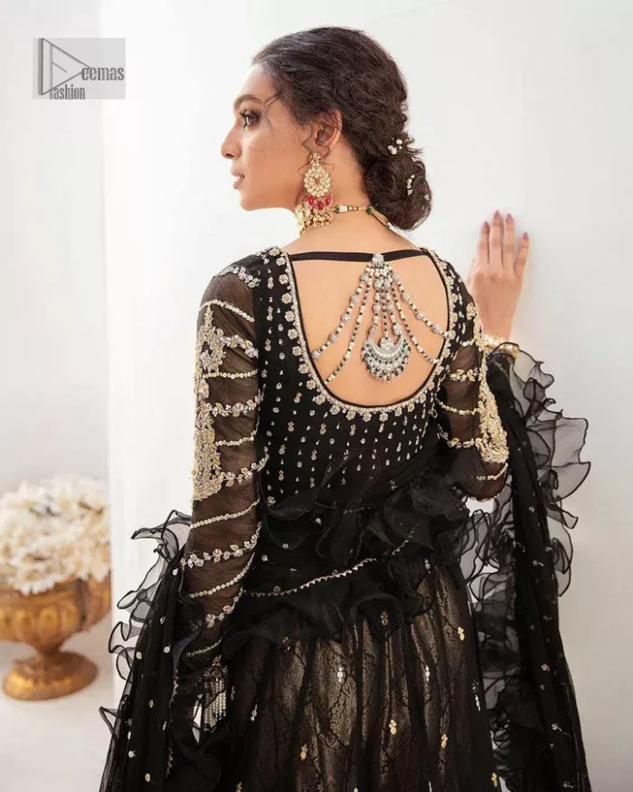 Let your outfit speak for the style tale itself! The frock, lehenga and dupatta combination is a breathtaking attire that comes in black colour. Traditional designs and hand-crafted embellishments on the frock which involves tilla, dabka, kora and Zardozi give a magnificent look to this perfectly. The beautiful light golden embroidery on full sleeves makes this article stunning and loving. It is paired with jamawar lehenga in the same colour to add some traditional look. Complete this party wear with a frilled dupatta sparkling with a sequin spray to make your day bright. 