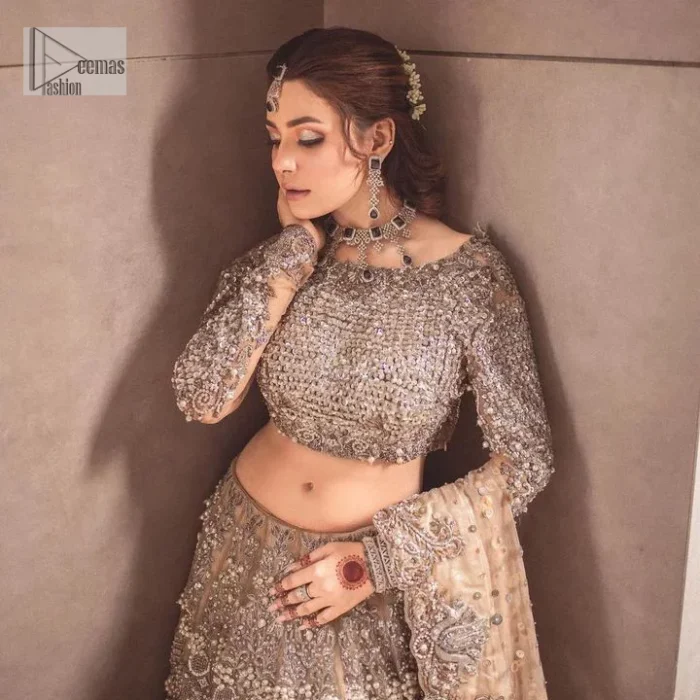 A dreamy statement of brown nikah outfit! This dress proffers a brown hue with its glamorous silver embroidery. The handsome and attractive embellishments include tilla, dabka, kora, Kundan and the real magic of Zardozi. The blouse has a boat-shaped neckline to enhance the features. Further, the floral patterns on full sleeves make this outfit more lovely. It is paired up with meticulously handcrafted lehnga which is bold enough to stand out in the crowd. Complete this article with a scalloped dupatta in the same colour framed with a four-sided border and sequin sprayed all over to make it dreamy.