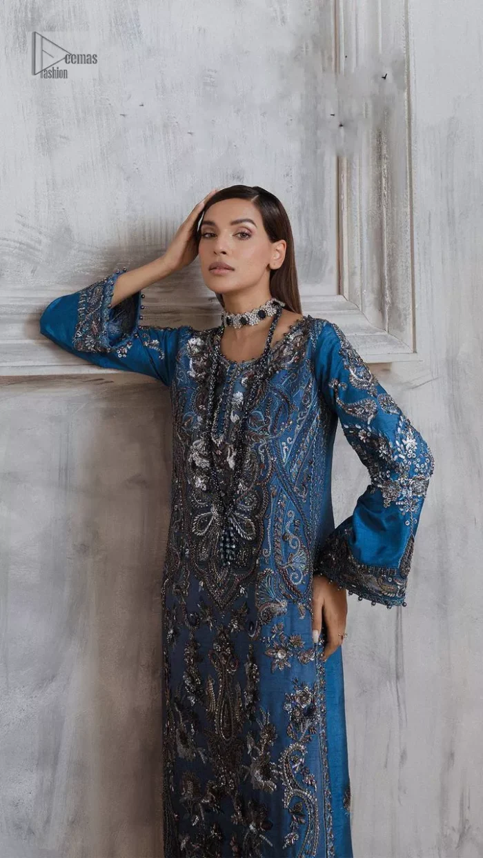 Dress up in this finest two-piece aesthetic party wear. A beautiful shirt in a cadet blue colour is a perfect choice to pair with trousers. The shirt is emblazoned with embroidery, threads, and floral designs. Hand-crafted details of tilla, dabka, Kora and Zardozi make this shirt a ravishing masterpiece. The round neckline is also decorated with attractive embroidery Furter, and the floral patterns on the sleeves give a handsome touch to the following shirt. It is systemized with plain ivory trousers to make a perfect combination which is a perfect choice.