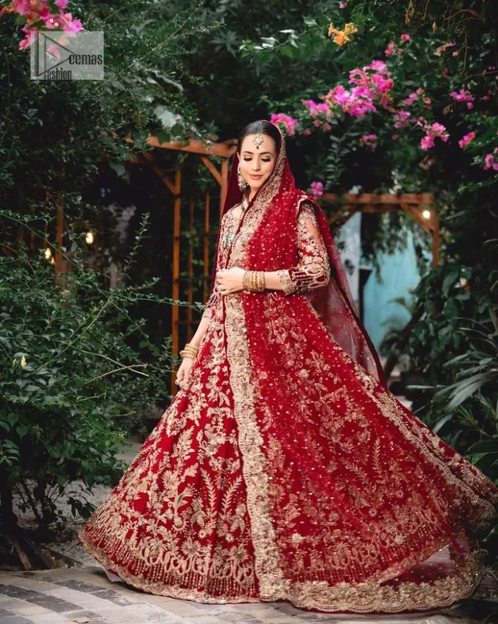 Classic deep red canvas with a bold twist of the pattern!  Bridal choli in the deep red shade is a beautiful attire to wear on the big day to have an elegant and classy look. This beautiful choli is heavily embellished with crystals, pearls, dabka,tilla, kora, Kundan, stones, and Zardozi giving a magnificent touch to the lehenga choli. The round neckline of the attractive blouse makes an outfit look more sophisticated. Further, the beautiful floral patterns on three-quarter sleeves make this outfit a must-have for your day. It is paired with a heavily embellished lehenga and is a stylish choice for the gorgeous Bride. Complete this romantic article with a dupatta framed with four-sided embellished borders and sequins sprayed all over.