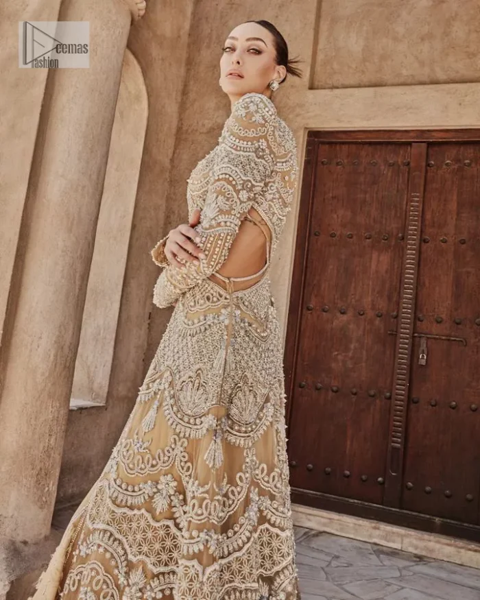 Bold, edgy, and wrapped in glamour. A sumptuous palette of gold with silver delicate embroidery, signature handcrafted embellishment includes tilla, dabka, kora, Kundan, Zardozi and crystals. Take your look to the next level with this golden front open gown which has V shape neckline and full sleeves. The floral patterns on the following gown just steal everyone's heart on your big day. It is paired up with a lehenga to enhance the beauty of this nikah outfit. Complete this article with a dupatta framed with four-sided embellished borders and sequins sprayed all over to wrap you in a bold outfit.