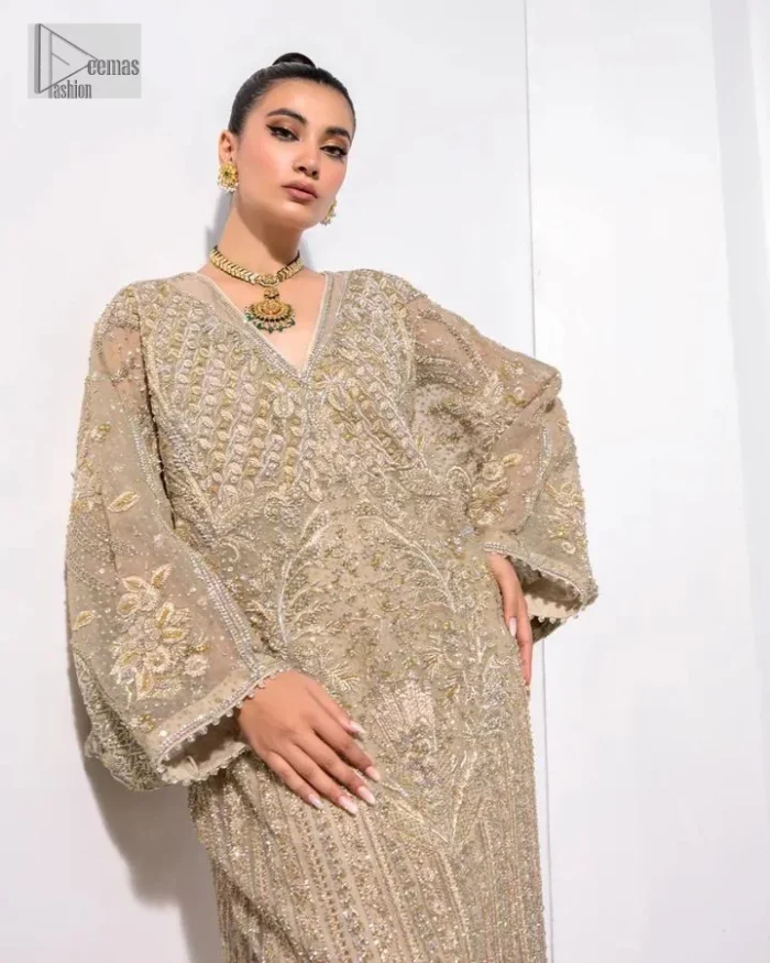 A little classy, a little sassy – that’s your style! An ivory floor-length kaftan with hand embellished work using dabka, naqshi, cut dana, Resham,  Mukesh, sequin and Kundan.  The beauty of this bridal lies in the geometric pattern of light golden embroidery. The V shape neckline is the finishing royal touch. Further, the floral motifs on full sleeves make this nikah outfit romantic and charming.  By layering this item, you can make any simple event better.