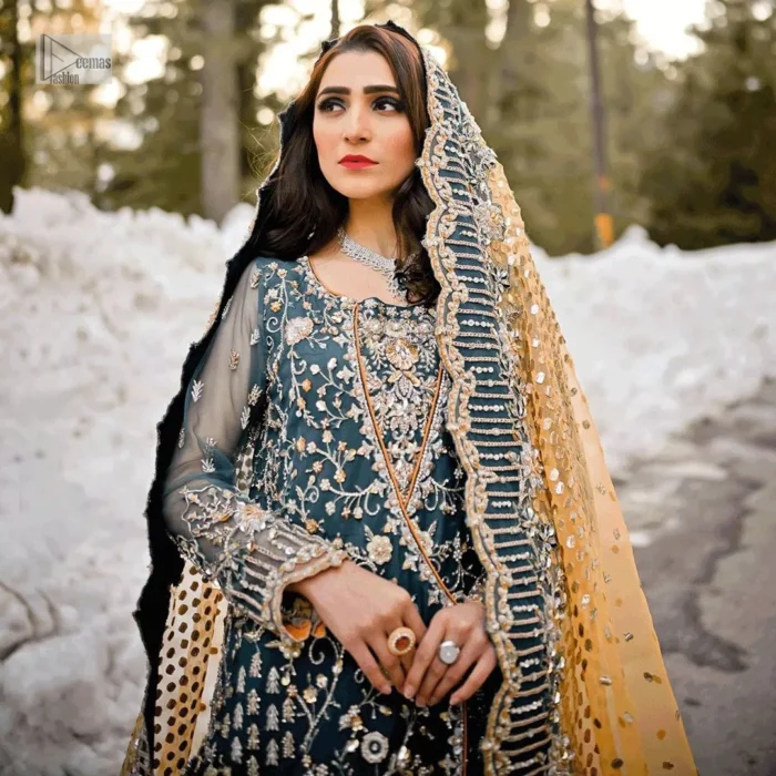 Crafted with silver and multiple shades of embroidery which includes tilla, dabka, kora, Kundan and the real magic of Zardozi, this ensemble showcases lively patterns and exquisite embroidery, its square neckline and angrakha style gives a touch of tradition to your special day.