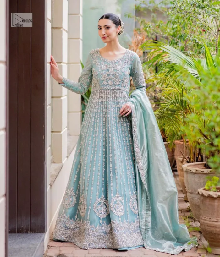 This attire showcases a harmonious fusion of traditional and modern design elements, adorned with intricate silver embellishments that include tilla, dabka, kora, Kundan and the real magic of Zardozi.
