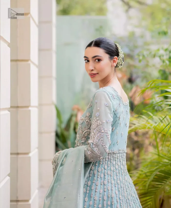 The fused lehenga is offered in a rich, sophisticated colour palette, ensuring you steal the spotlight with your regal presence. Finish this article with a dupatta framed with four-sided embellished borders and sequins spray.