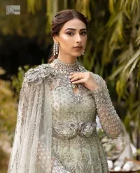 This enchanting ensemble features intricate silver and grey embroidery which involves tilla, dabka, kora, Kundan, and luxurious fabrics, making it a symbol of grace and sophistication.