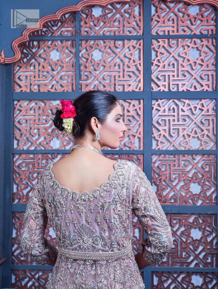Tea Pink are always the hot trend for the walima outfit. Traditional designs and hand-crafted embellishments of the following maxi give a magnificent look to this perfect outfit. It is adorned with silver embroidery which involves tilla, dabka, Kora, Kundan and the real magic of crystals. The boat shape neckline has fine details and intricate designs. Further, the style of the three-quarter sleeves makes this masterpiece super stunning. It is paired with a lehenga in the same colour which is plain to balance the overall charm of the outfit. Finish this article with a dupatta which has an intricate embellished design on borders and sequins spray all over to make this dress a chic masterpiece.