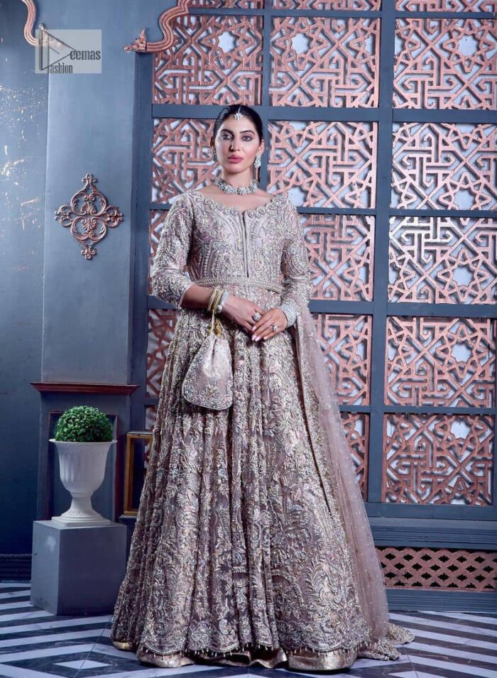 Tea Pink are always the hot trend for the walima outfit. Traditional designs and hand-crafted embellishments of the following maxi give a magnificent look to this perfect outfit. It is adorned with silver embroidery which involves tilla, dabka, Kora, Kundan and the real magic of crystals. The boat shape neckline has fine details and intricate designs. Further, the style of the three-quarter sleeves makes this masterpiece super stunning. It is paired with a lehenga in the same colour which is plain to balance the overall charm of the outfit. Finish this article with a dupatta which has an intricate embellished design on borders and sequins spray all over to make this dress a chic masterpiece.