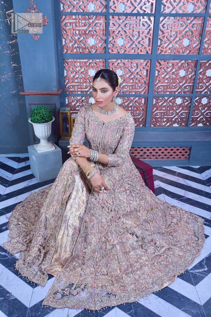 Tea Pink are always the hot trend for the walima outfit. Traditional designs and hand-crafted embellishments of the following maxi give a magnificent look to this perfect outfit. It is adorned with silver embroidery which involves tilla, dabka, Kora, Kundan and the real magic of crystals. The boat shape neckline has fine details and intricate designs. Further, the style of the three-quarter sleeves makes this masterpiece super stunning. It is paired with a lehenga in the same colour which is plain to balance the overall charm of the outfit. Finish this article with a dupatta which has an intricate embellished design on borders and sequins spray all over to make this dress a chic masterpiece.