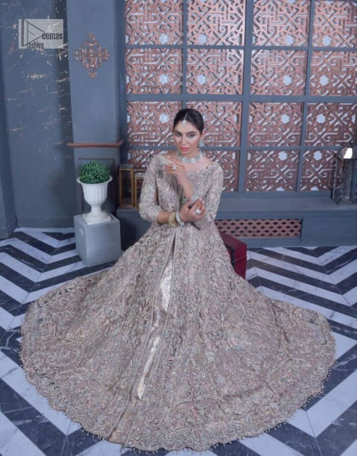 Tea Pink are always the hot trend for the walima outfit. Traditional designs and hand-crafted embellishments of the following maxi give a magnificent look to this perfect outfit. It is adorned with silver embroidery which involves tilla, dabka, Kora, Kundan and the real magic of crystals. The boat shape neckline has fine details and intricate designs. Further, the style of the three-quarter sleeves makes this masterpiece super stunning. It is paired with a lehenga in the same colour which is plain to balance the overall charm of the outfit. Finish this article with a dupatta which has an intricate embellished design on borders and sequins spray all over to make this dress a chic masterpiece.