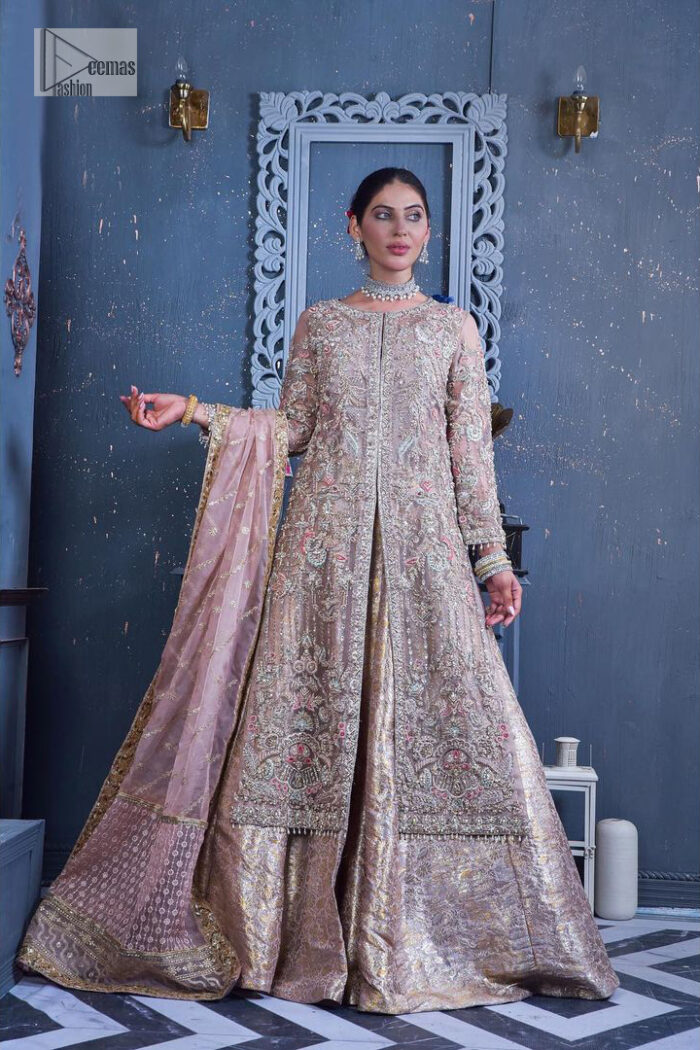 Get cosy in a tea rose nikah outfit. DeemasFashion presents this tea rose front open gown which is heavily embroidered in multiple colours and then further enhanced with the heavy embellishment of tilla, dabka, kora, Kundan and Zardozi making it a perfect fit for brides. The stones touch-up on the round neckline increases the look of the beautiful gown. Furthermore, the full sleeves style of the following gown makes this masterpiece stunning and stylish. It is paired up with flared lehenga in the same colour to balance the overall look of this magnificent attire. Finish this with a dupatta having four-sided borders that gives an everlasting impact on the bride.