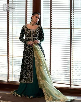 Outfits that define you. DeemasFashion presents the party wear in deep green colour which is adorned with light golden embroidery. It is enhanced with tilla, dabka, kora Kundan and the real magic of Zardozi. The round neckline makes this epitome of beauty. Furthermore, the full sleeves of the front open gown intensify the beauty of the outfit. It is coordinated with a plain lehenga with a border embellished to make you feel fresh and bold at the same time. Complete this attire with a dupatta in ivory colour which is ornamented with a four-sided embellished border to give a royal touch.